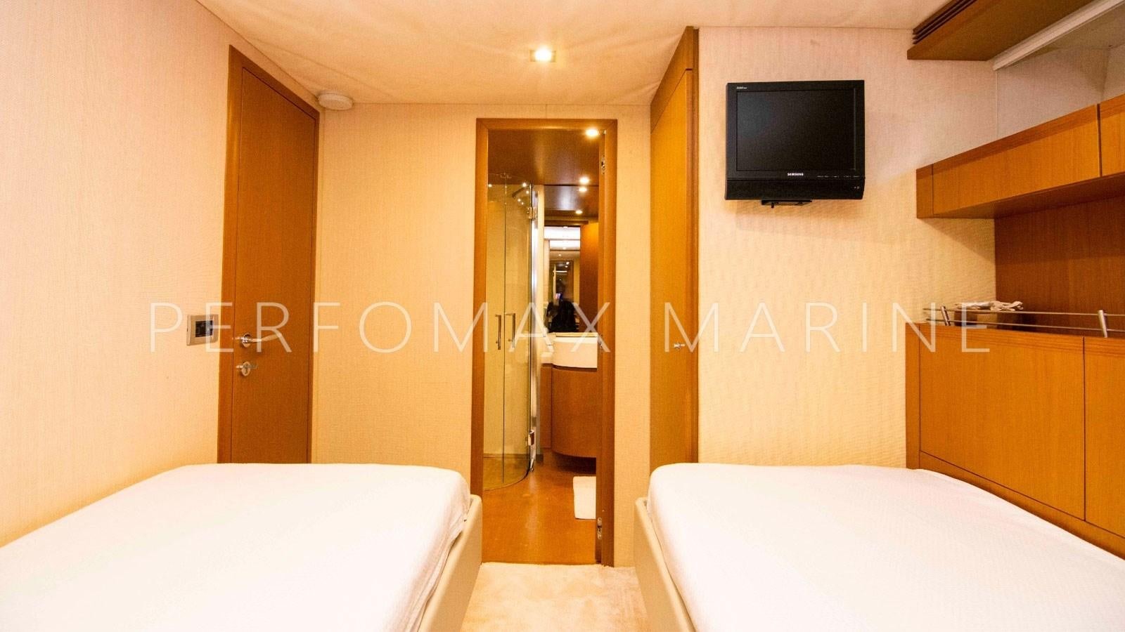 a room with a bed and a television on the wall aboard F78 Yacht for Sale