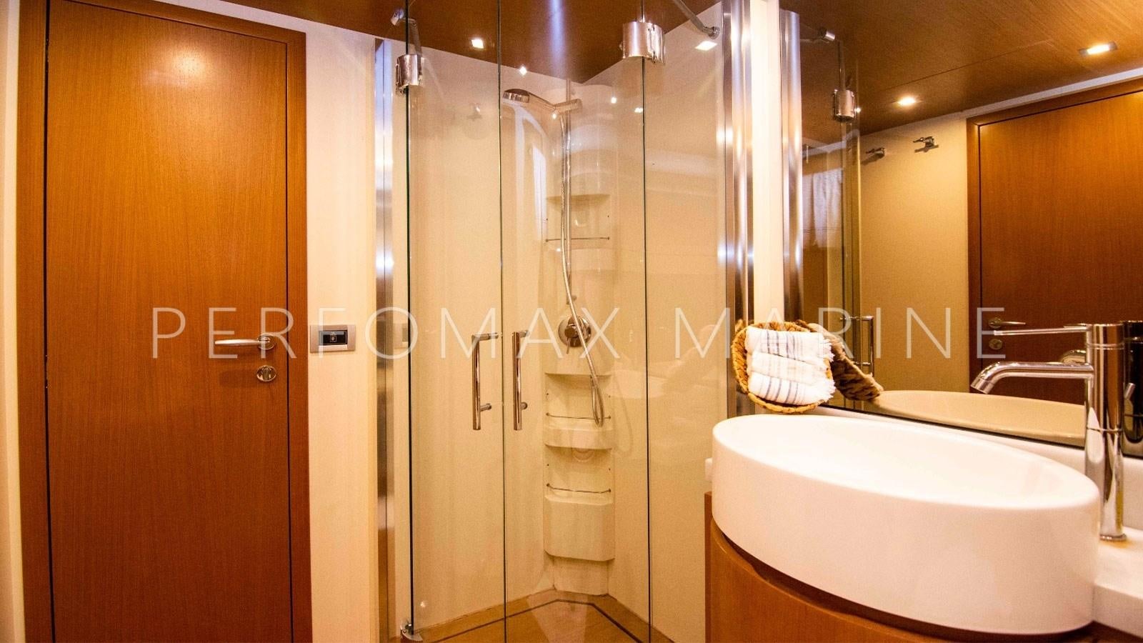 a bathroom with a glass shower aboard F78 Yacht for Sale