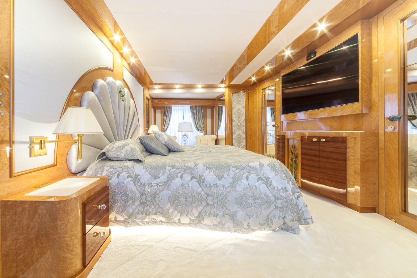 a bed with a blue comforter aboard DUCHESSA Yacht for Sale