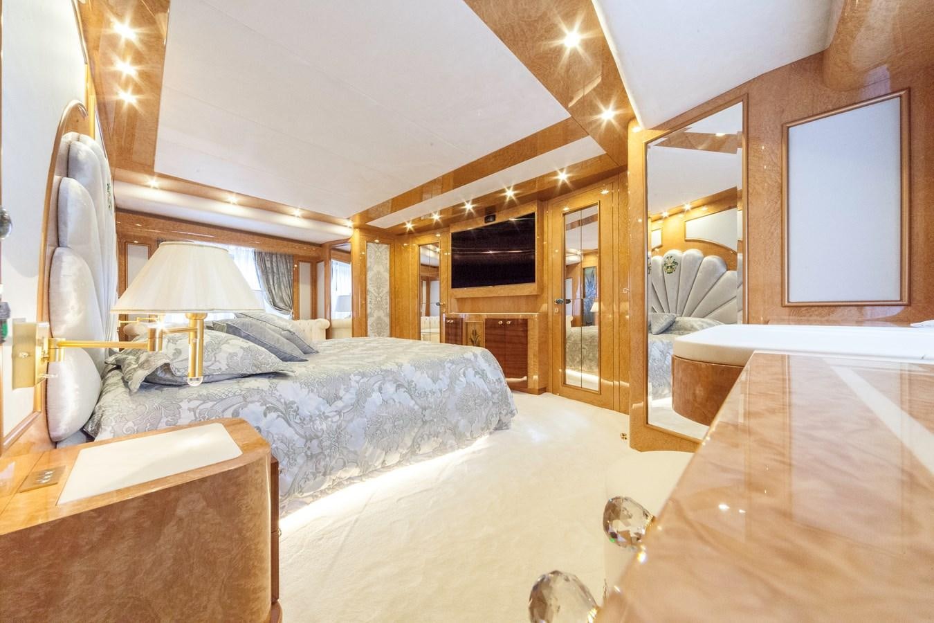 a bedroom with a bed and a mirror aboard DUCHESSA Yacht for Sale