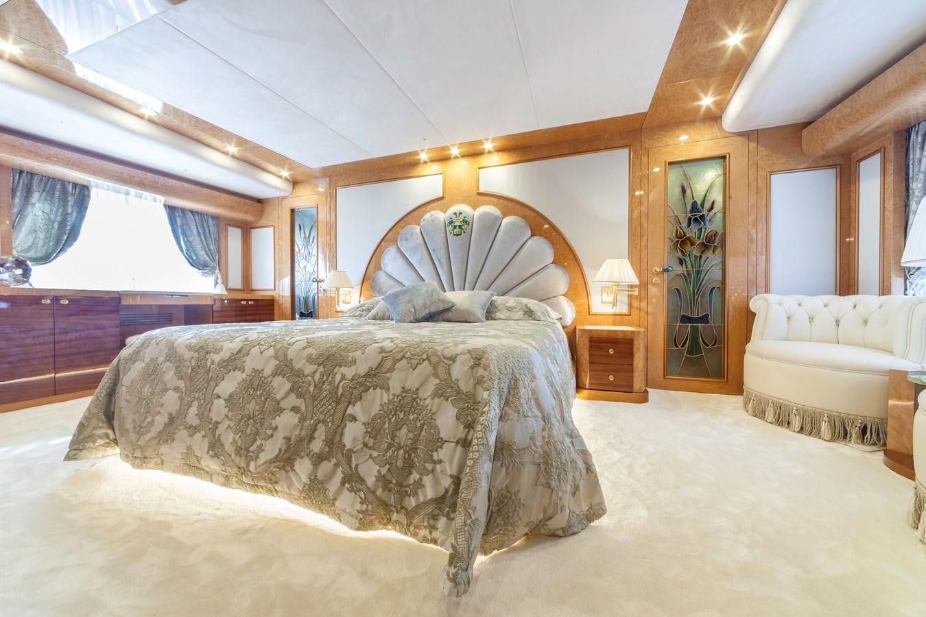 a bedroom with a bed and a window aboard DUCHESSA Yacht for Sale