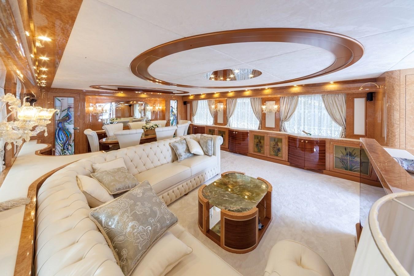 a large living room with a large chandelier aboard DUCHESSA Yacht for Sale
