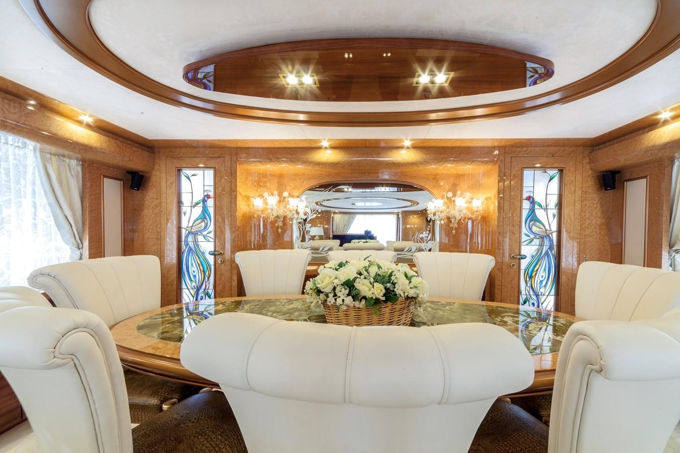 a large living room with a large chandelier aboard DUCHESSA Yacht for Sale