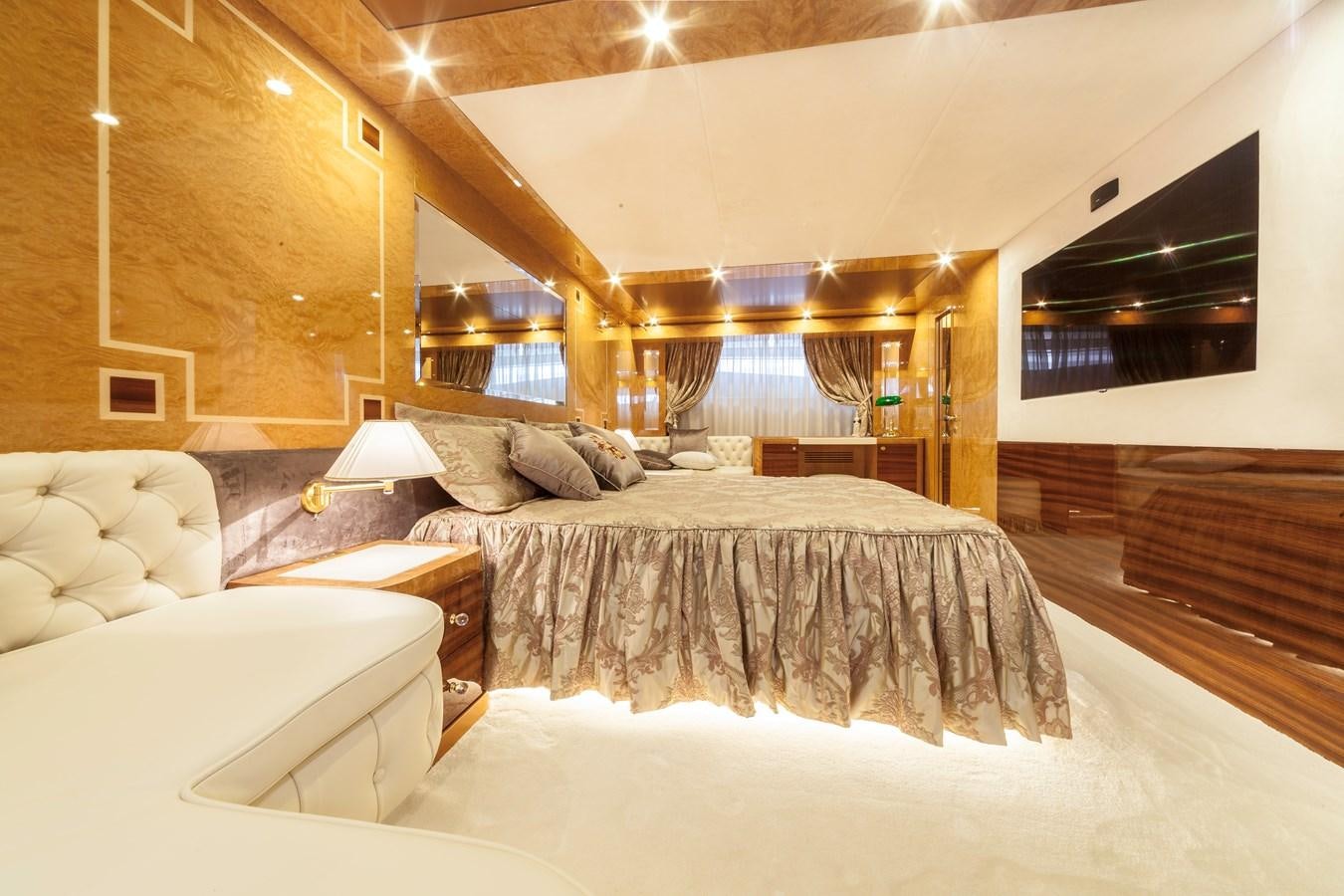 a room with a bed and a table aboard DUCHESSA Yacht for Sale