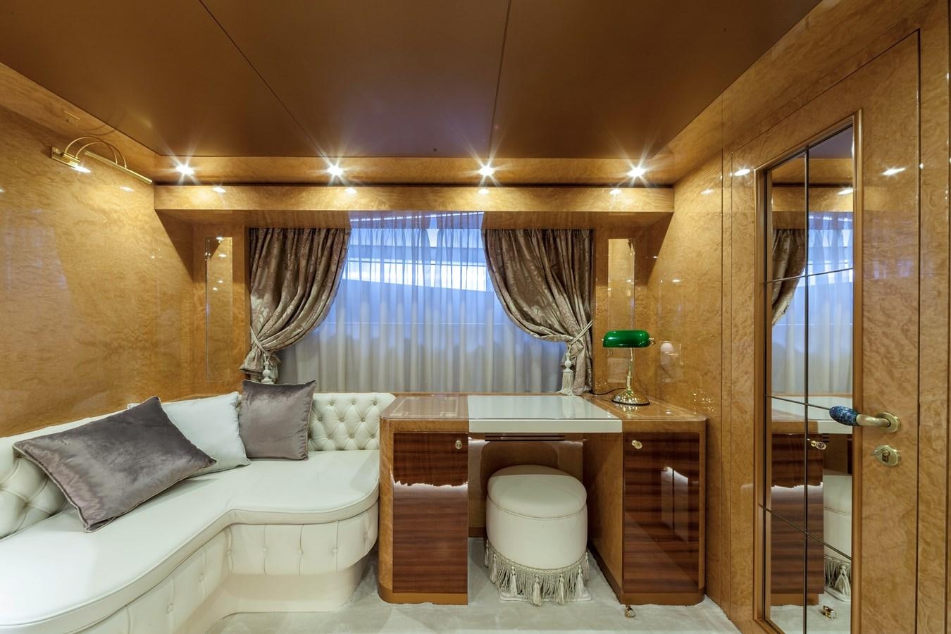 a room with a bed and a table aboard DUCHESSA Yacht for Sale