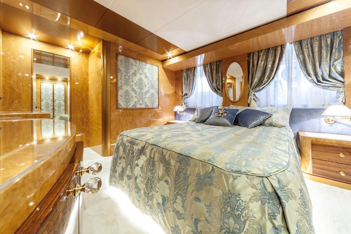 a bedroom with a bed and a mirror aboard DUCHESSA Yacht for Sale