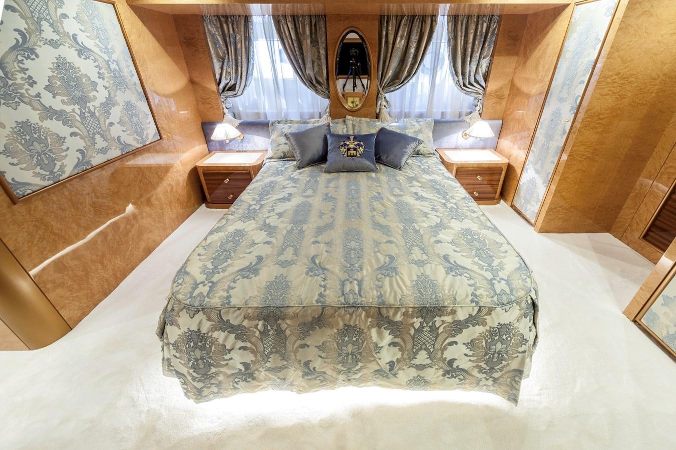 a bed with a blue sheet aboard DUCHESSA Yacht for Sale