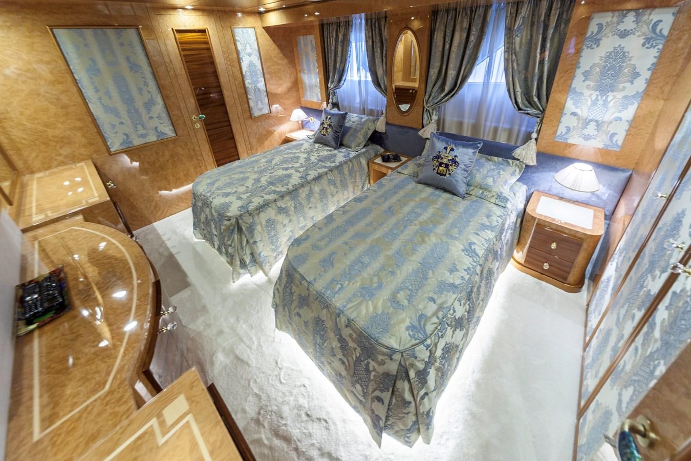 a room with a bed and a desk aboard DUCHESSA Yacht for Sale