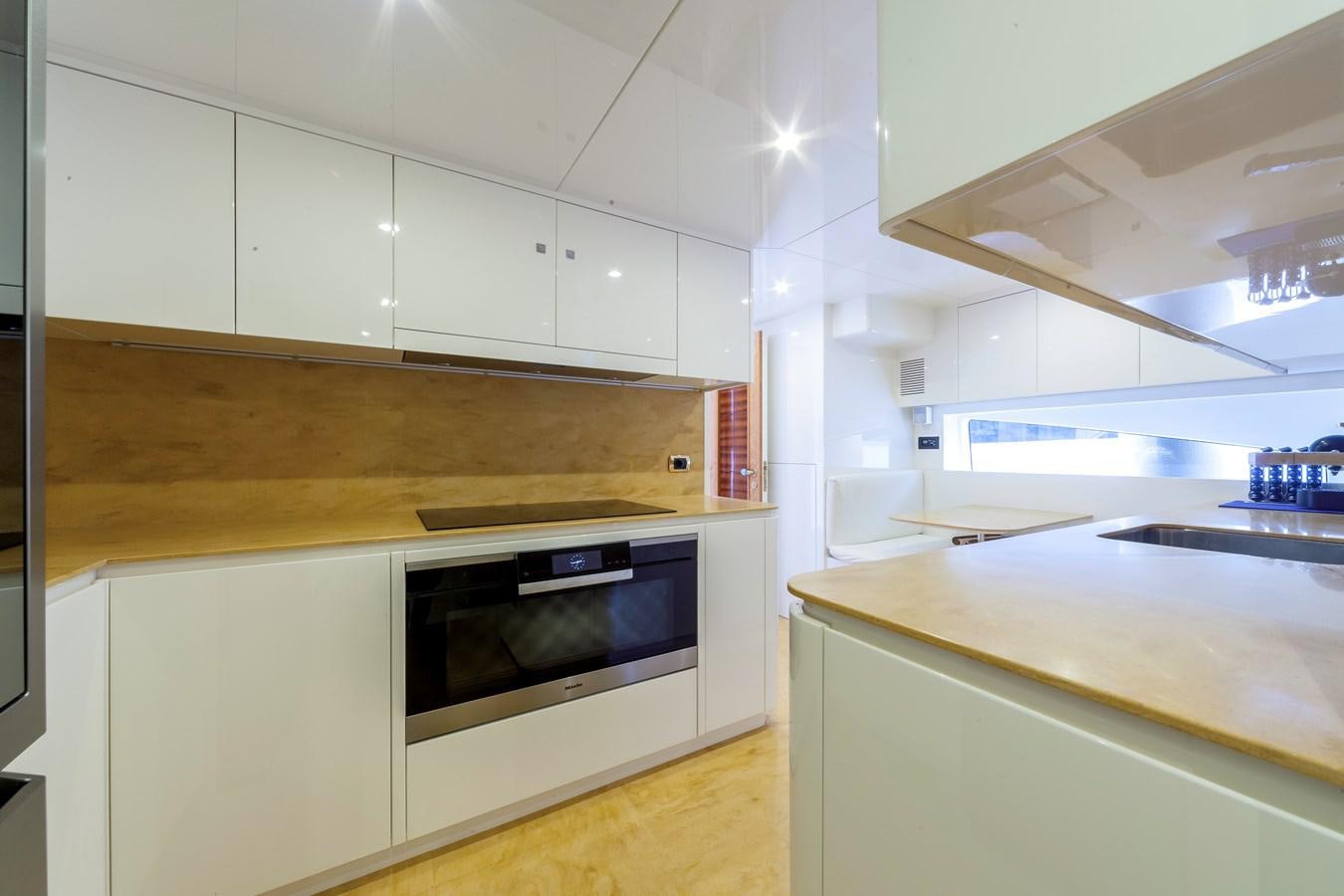 a kitchen with white cabinets aboard DUCHESSA Yacht for Sale