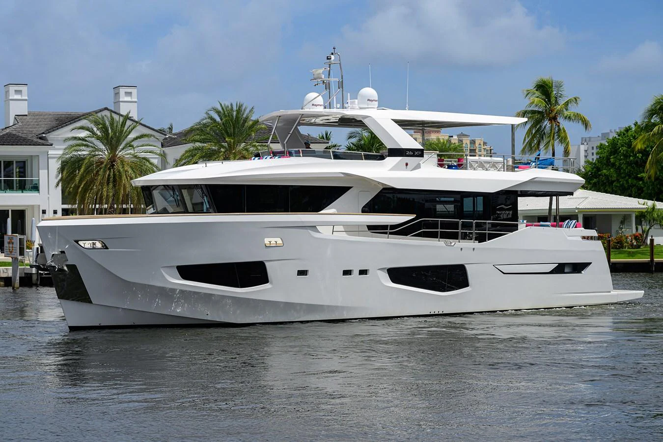 a white yacht in a harbor aboard C3 Yacht for Sale