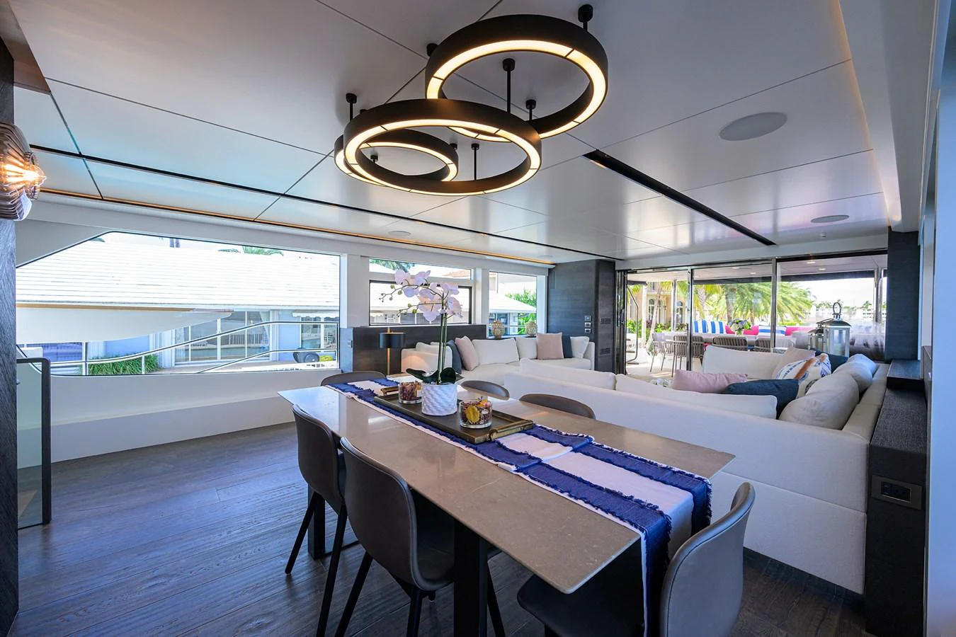 a large room with a table and chairs aboard C3 Yacht for Sale