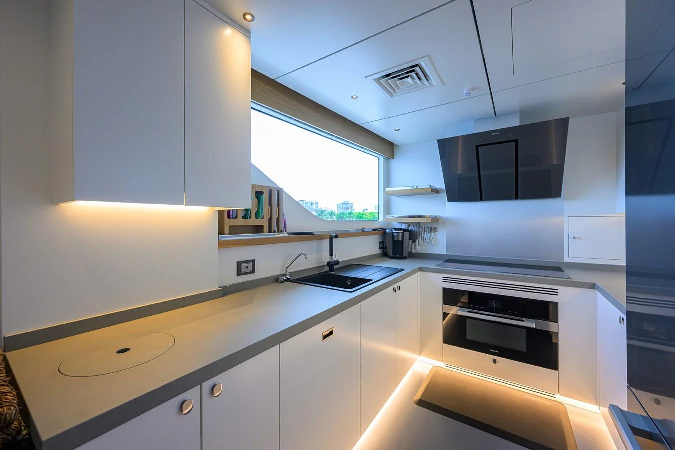 a kitchen with white cabinets aboard C3 Yacht for Sale