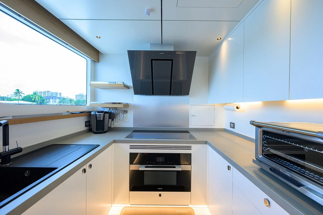 a kitchen with black appliances aboard C3 Yacht for Sale
