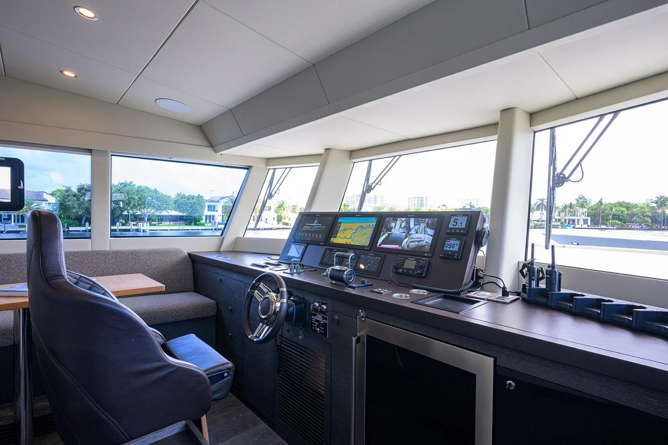 inside of a vehicle with a large window and a desk with computer and chairs aboard C3 Yacht for Sale