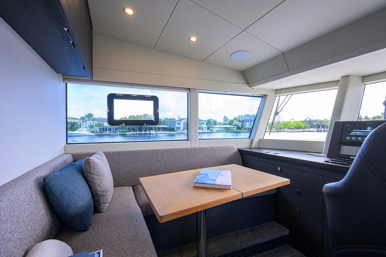 a room with a couch and a table and a window aboard C3 Yacht for Sale