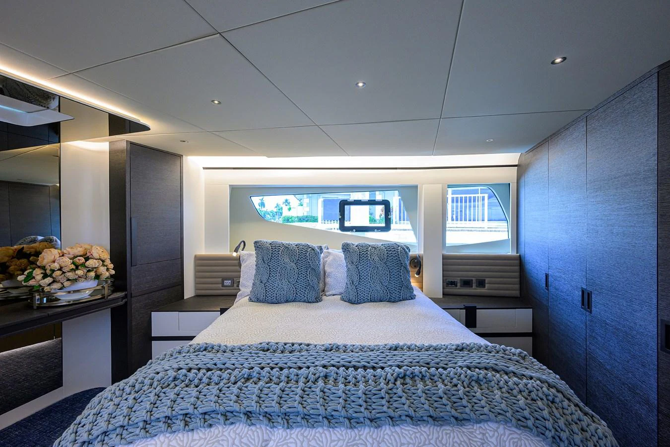 a bed with a blue and white checkered blanket aboard C3 Yacht for Sale