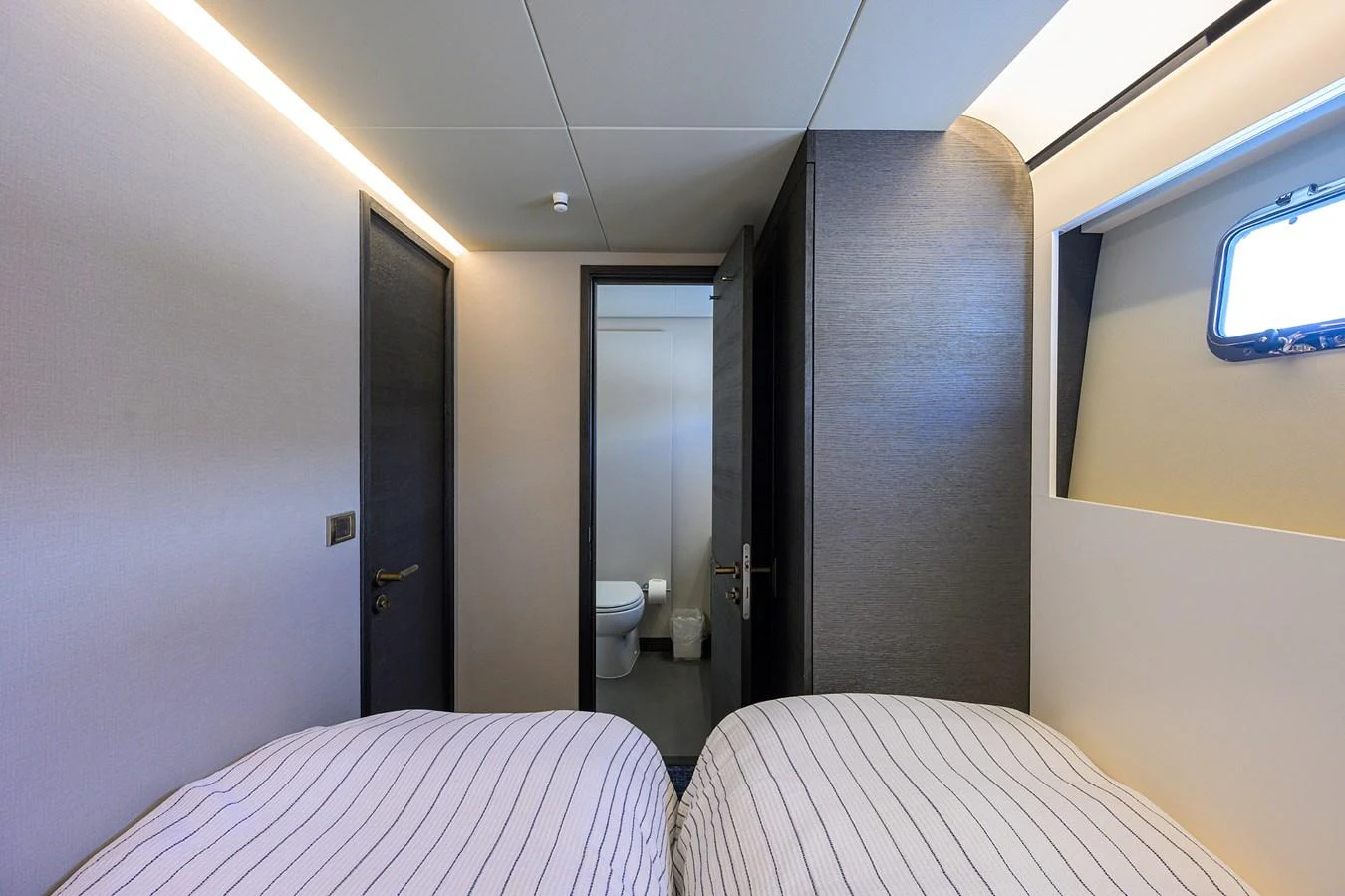 a room with a bed and a door aboard C3 Yacht for Sale
