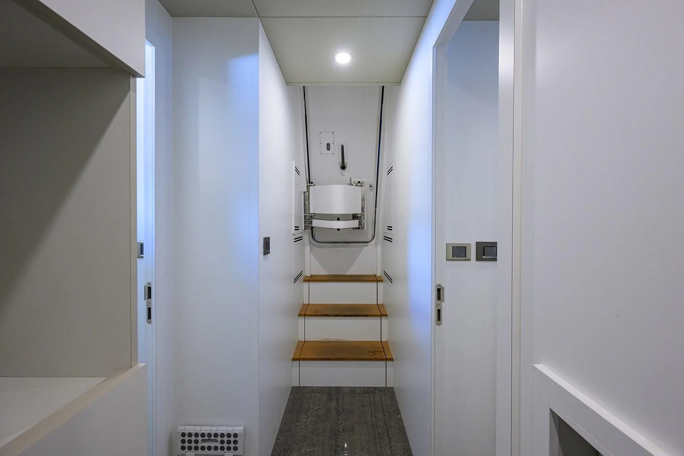 a hallway with white doors aboard C3 Yacht for Sale