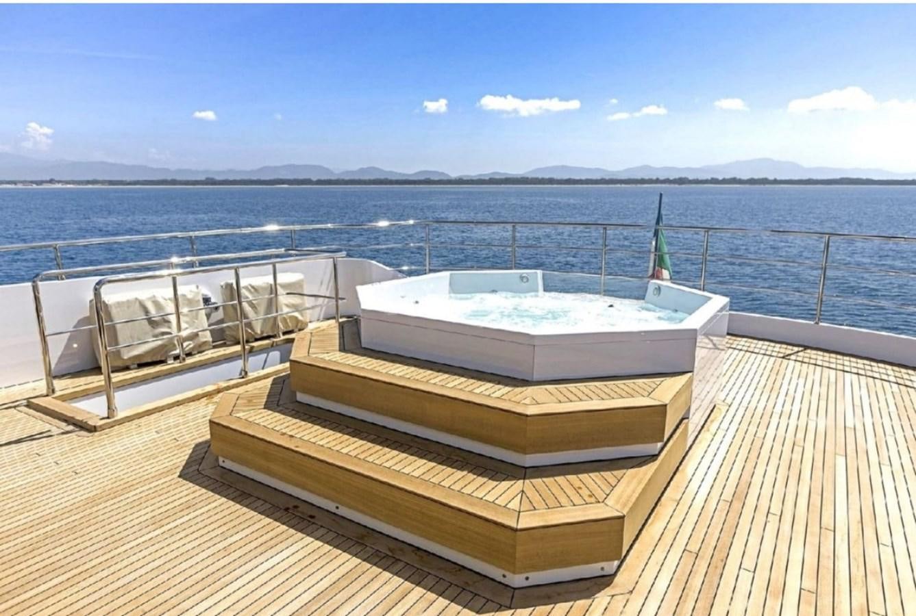 a deck with a view of the ocean and a city aboard EDEN Yacht for Sale