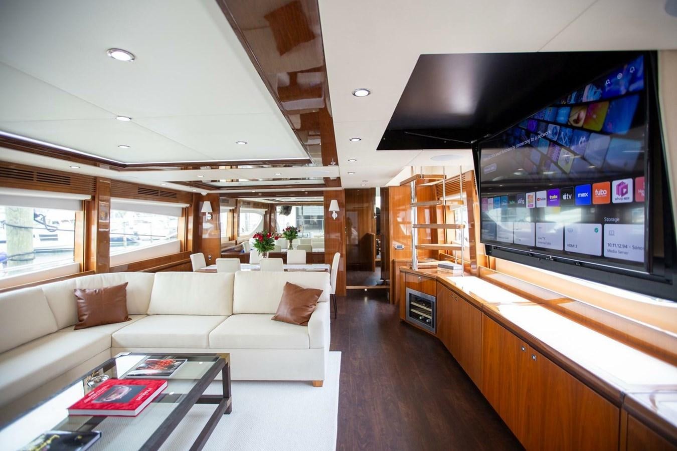 a living room with a large screen aboard ENTOURAGE Yacht for Sale