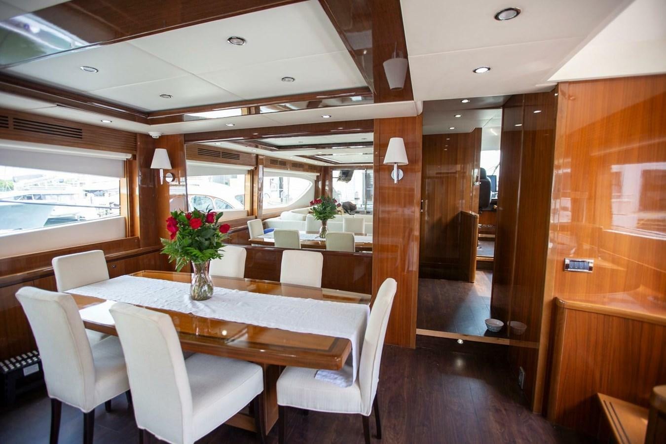 a dining room with a table and chairs aboard ENTOURAGE Yacht for Sale