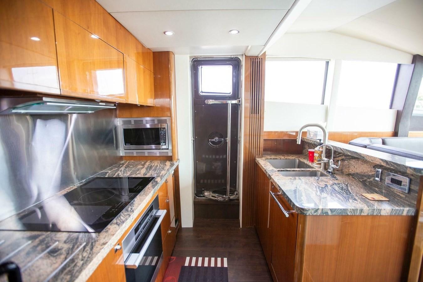 a kitchen with wooden cabinets aboard ENTOURAGE Yacht for Sale