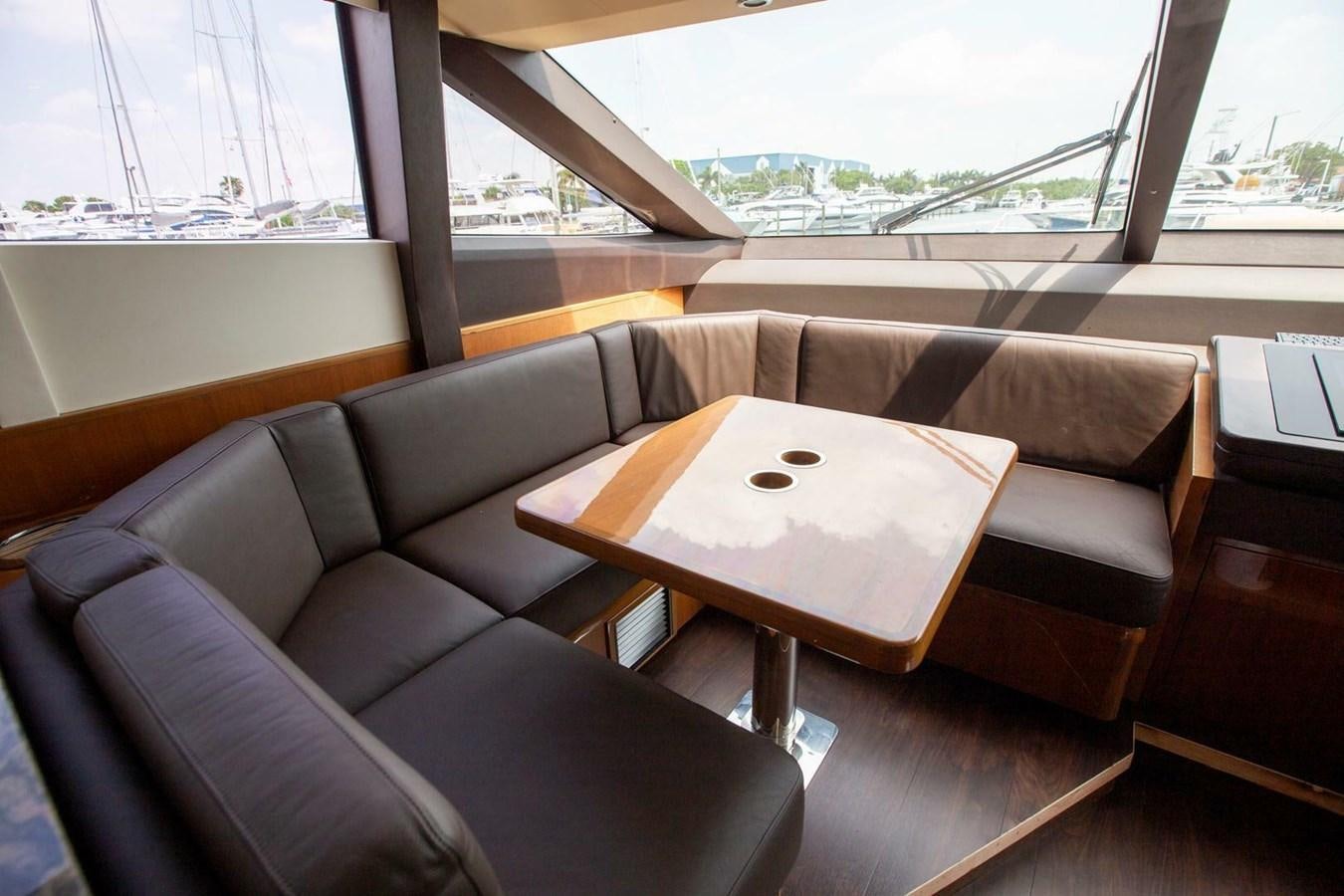 a couch and a table in a room aboard ENTOURAGE Yacht for Sale