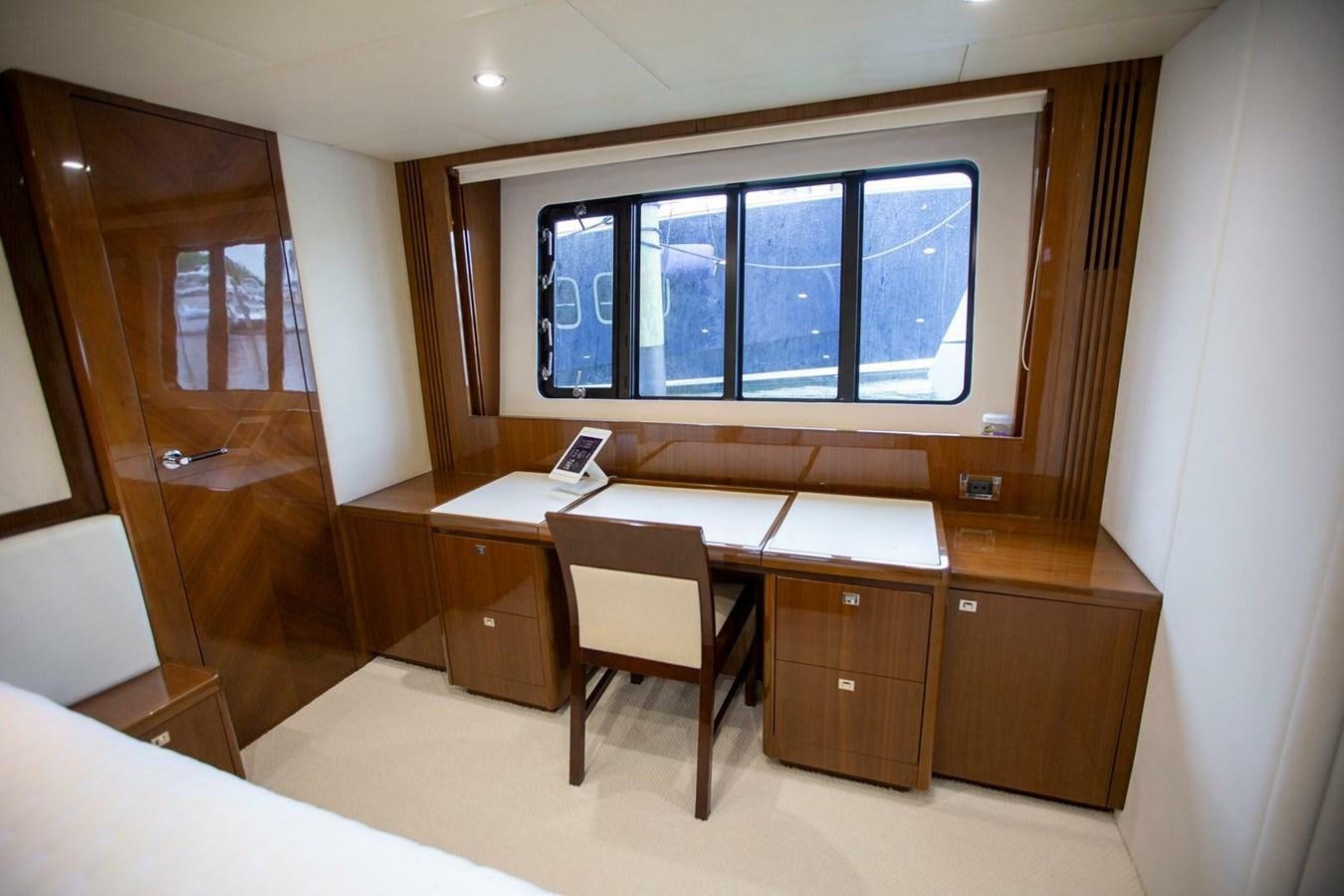 a room with a desk and a window aboard ENTOURAGE Yacht for Sale