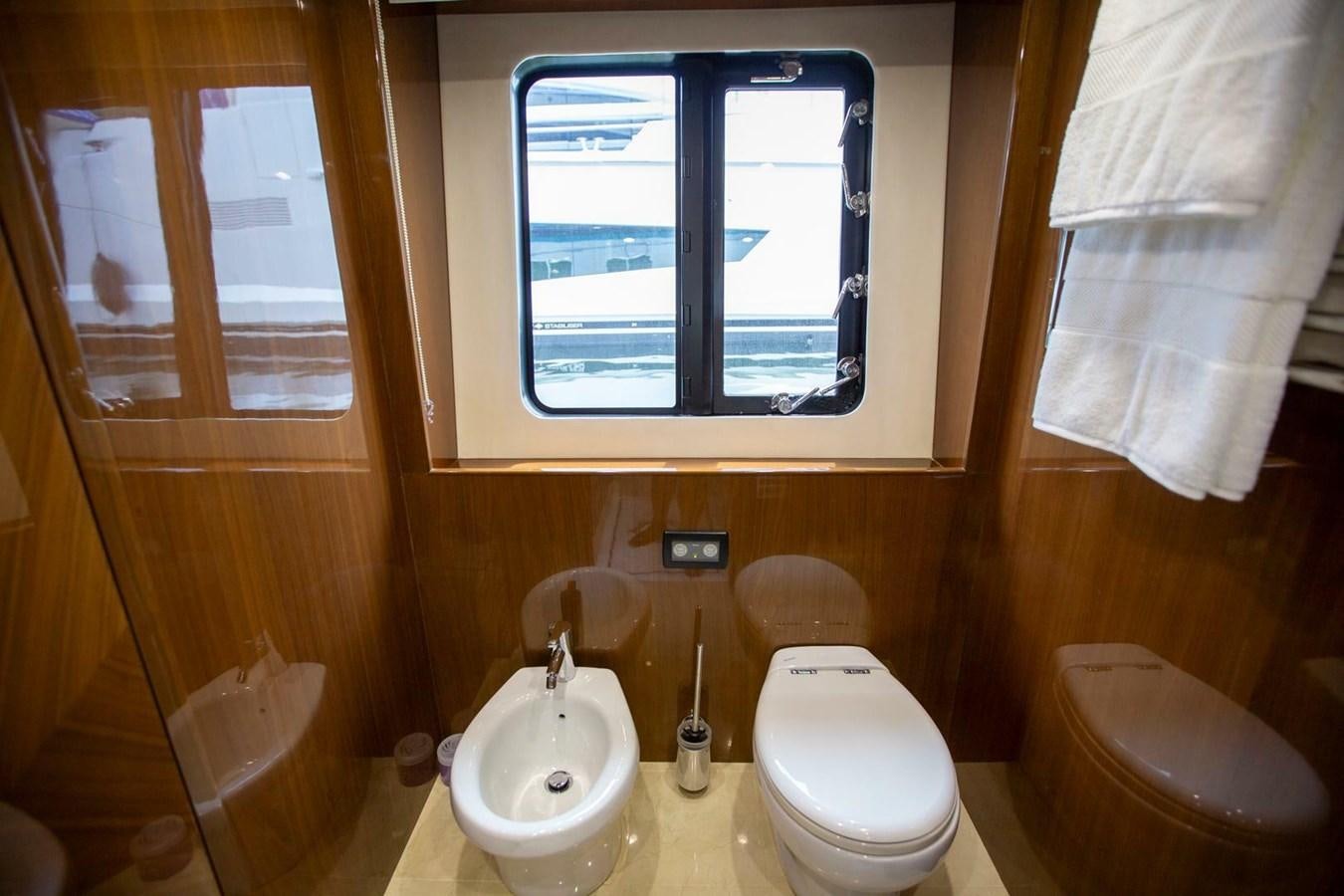 a bathroom with a toilet and a sink aboard ENTOURAGE Yacht for Sale