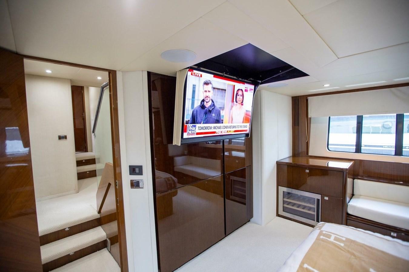 a room with a tv and a couch aboard ENTOURAGE Yacht for Sale