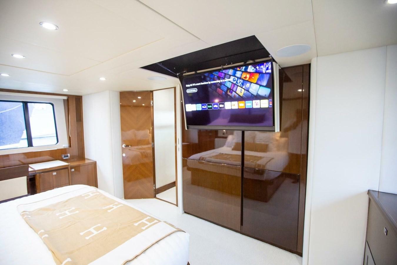 a room with a tv and a table aboard ENTOURAGE Yacht for Sale