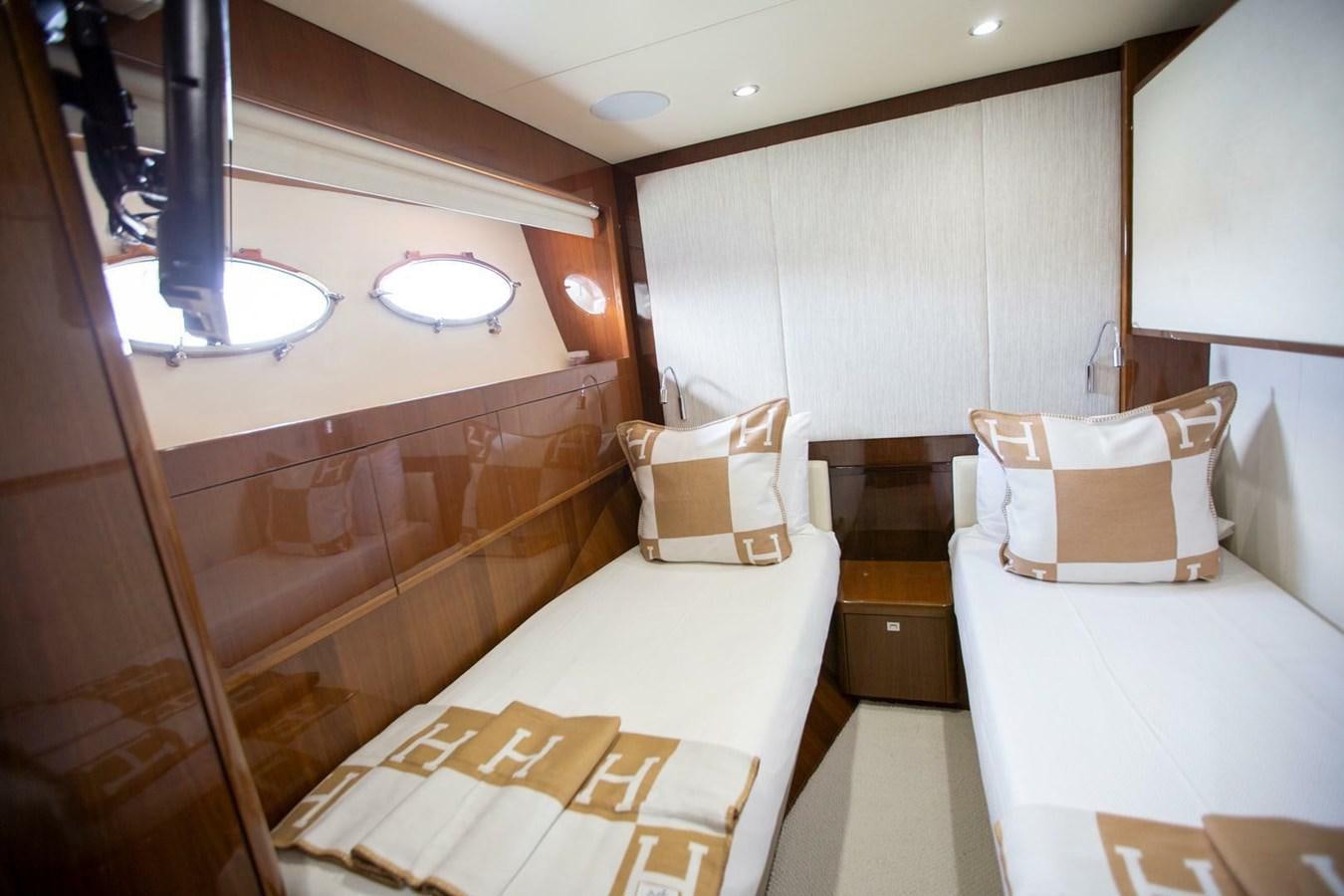 a room with a bed and a mirror aboard ENTOURAGE Yacht for Sale