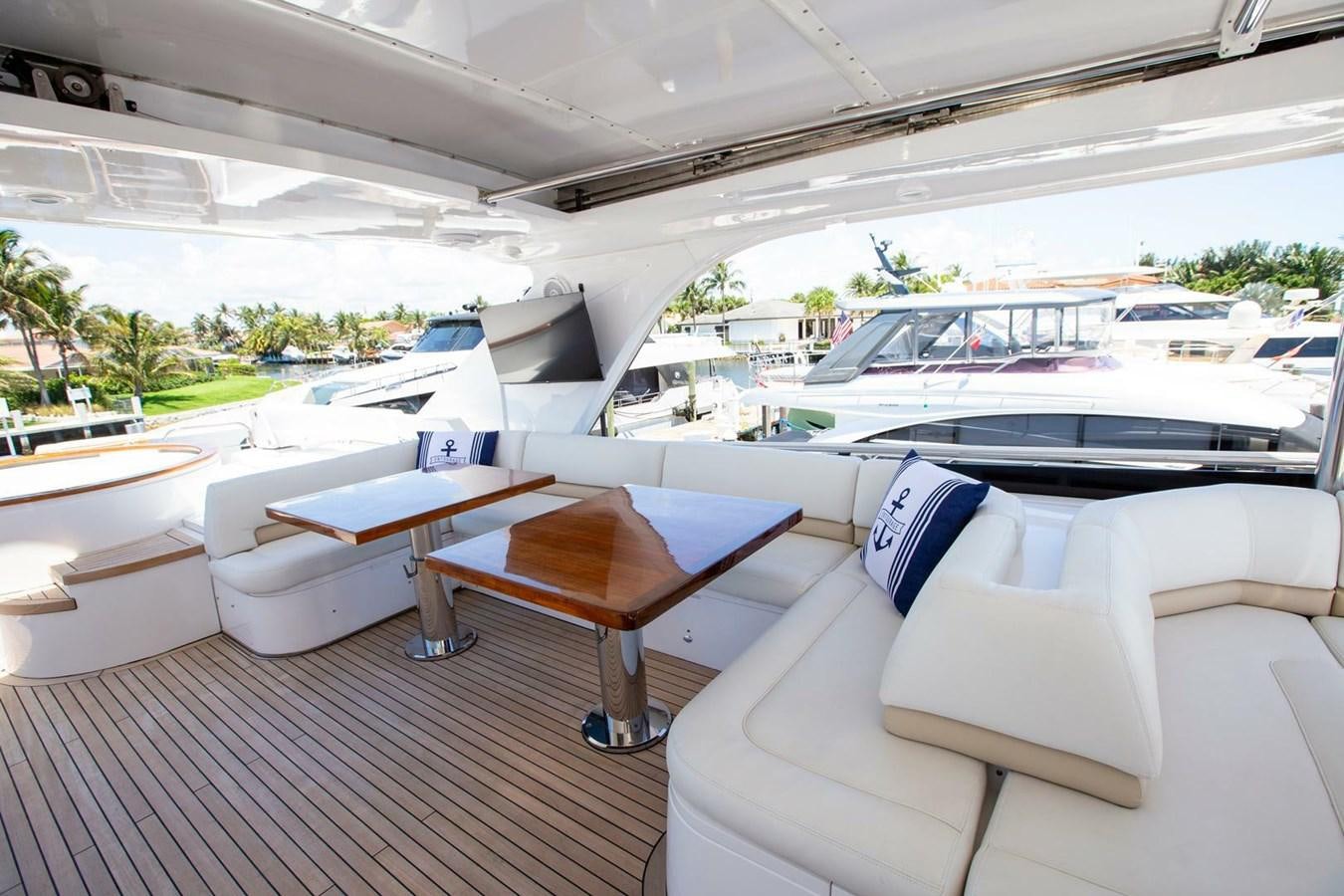 a room with a table and chairs aboard ENTOURAGE Yacht for Sale