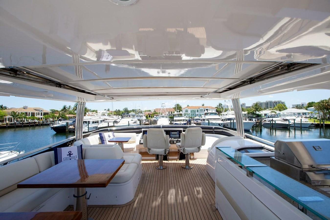 a deck with a view of a city and water aboard ENTOURAGE Yacht for Sale