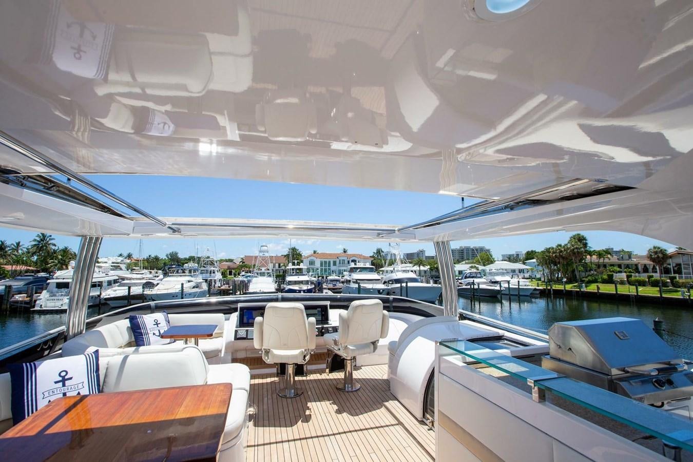 a boat with a deck and chairs aboard ENTOURAGE Yacht for Sale