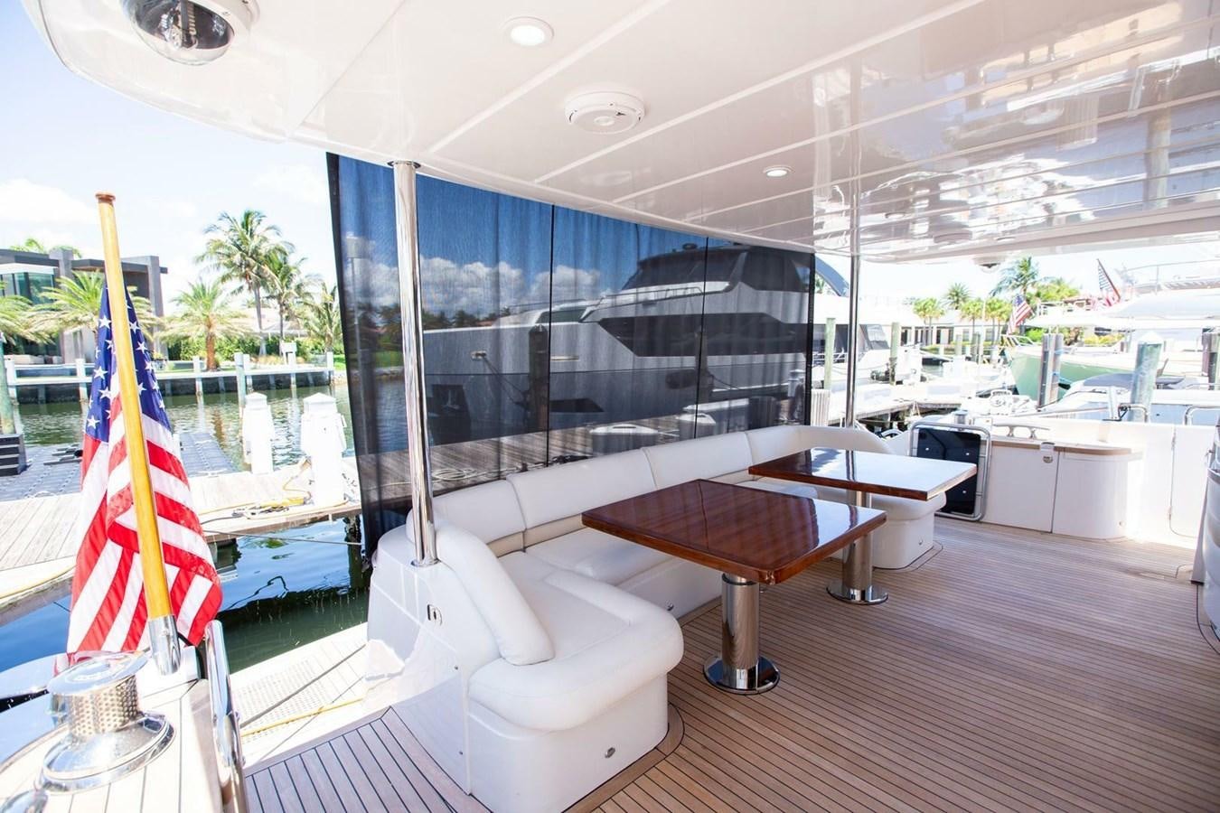 a room with a bench and a table and chairs aboard ENTOURAGE Yacht for Sale