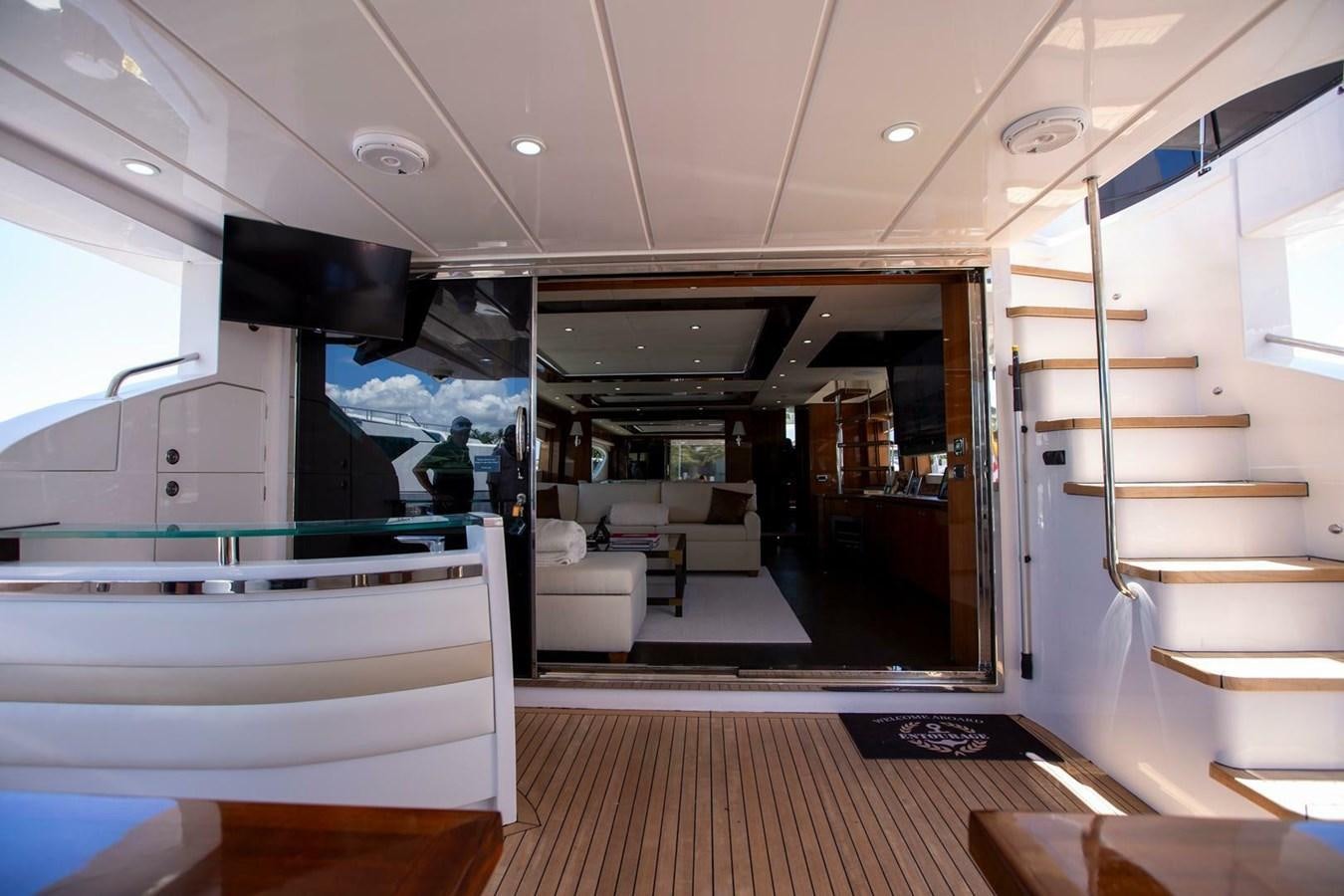 a modern looking room with a wood floor and white cabinets aboard ENTOURAGE Yacht for Sale