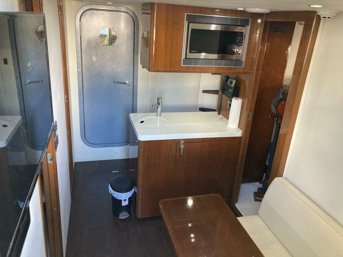 a kitchen with a sink and microwave aboard ENTOURAGE Yacht for Sale