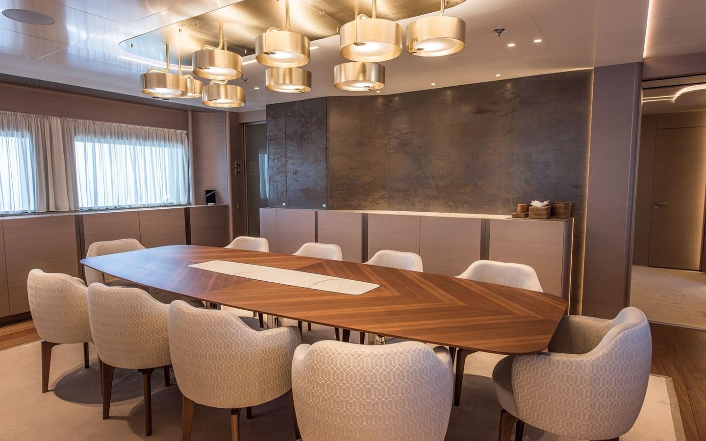 a room with a table and chairs aboard FLORENTIA Yacht for Sale