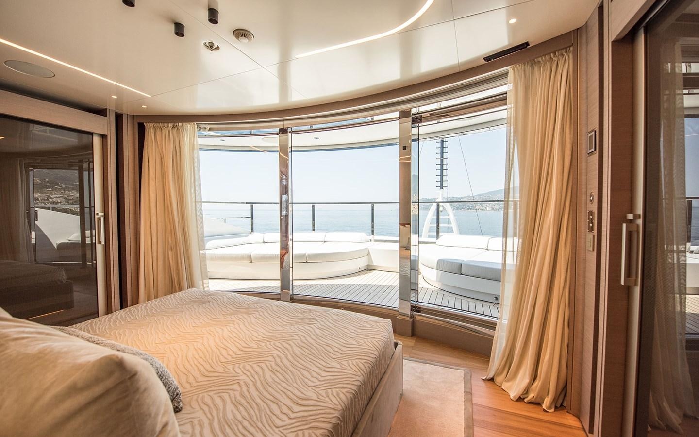 a bedroom with a large window aboard FLORENTIA Yacht for Sale