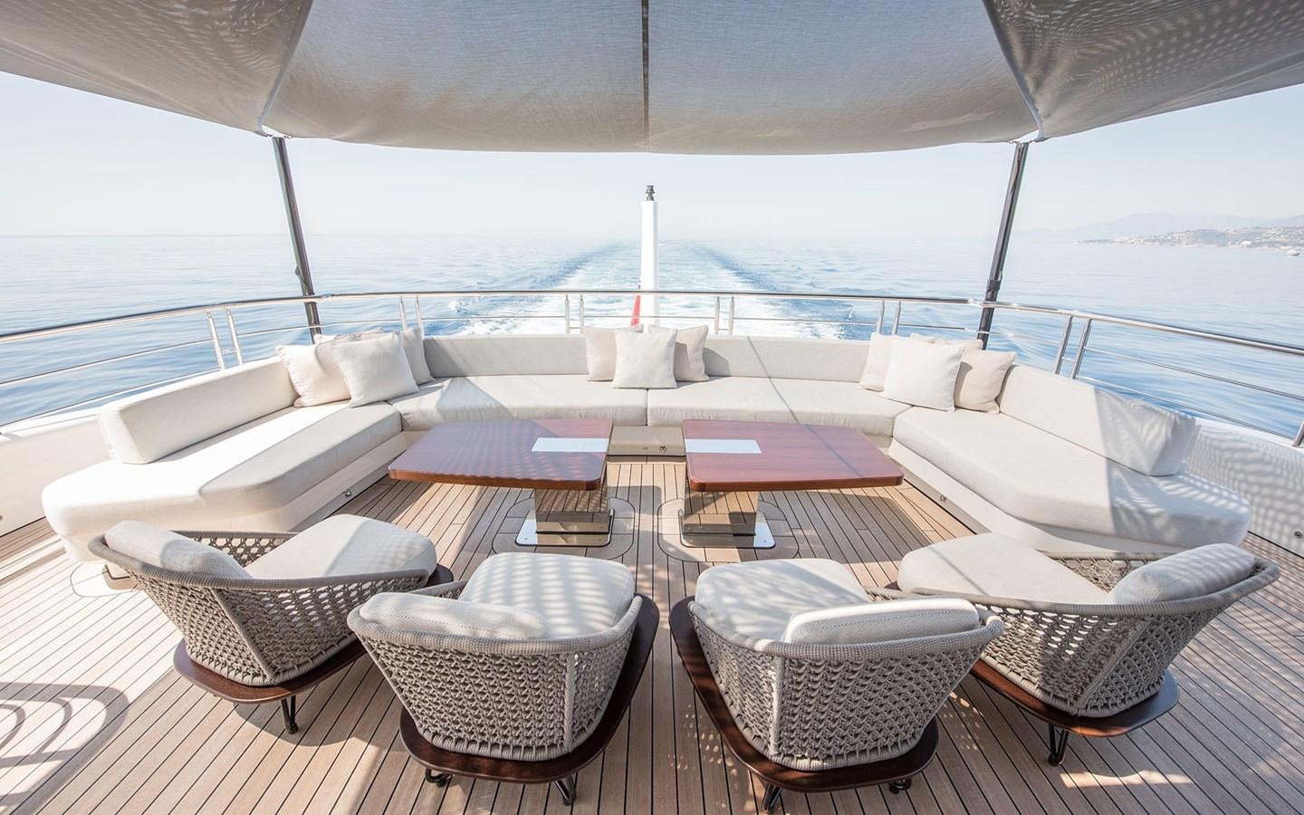 a lounge area with a large swimming pool and chairs aboard FLORENTIA Yacht for Sale