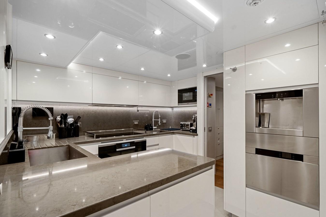 a kitchen with white cabinets aboard 2017 CANTIERE DELLE MARCHE DARWIN/ATLAS Yacht for Sale