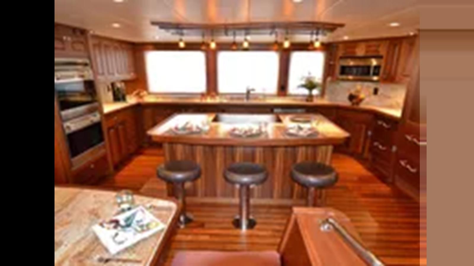 a kitchen with a bar and stools aboard 2018 ALLSEAS EXPEDITION Yacht for Sale