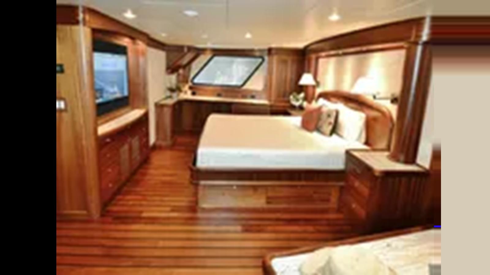 a bedroom with a bed and a tv aboard 2018 ALLSEAS EXPEDITION Yacht for Sale