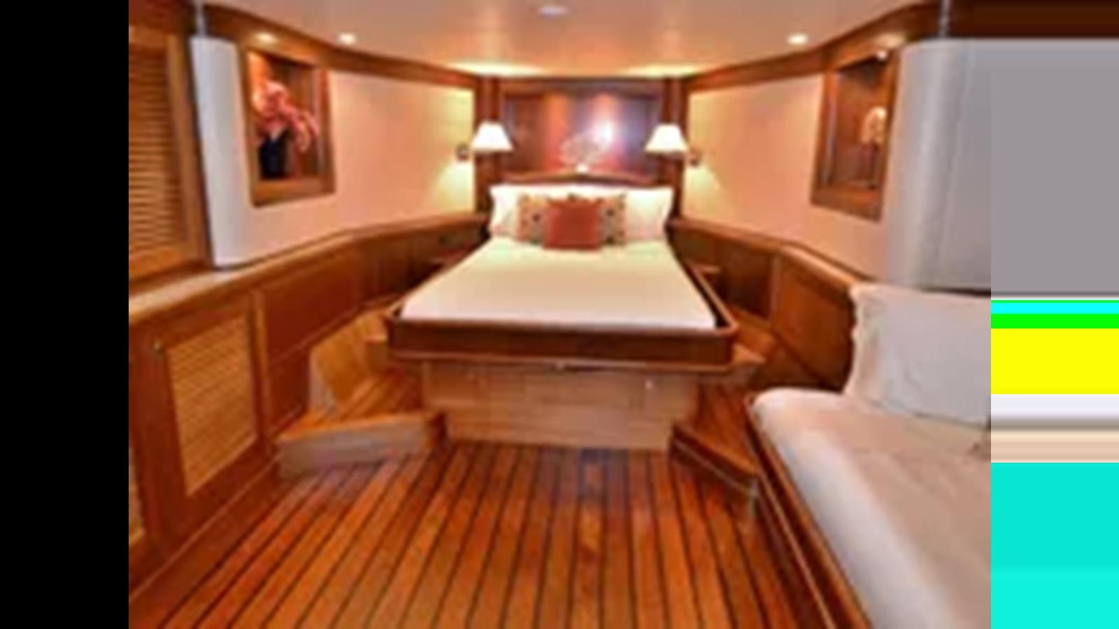 a room with a bed and a table aboard 2018 ALLSEAS EXPEDITION Yacht for Sale