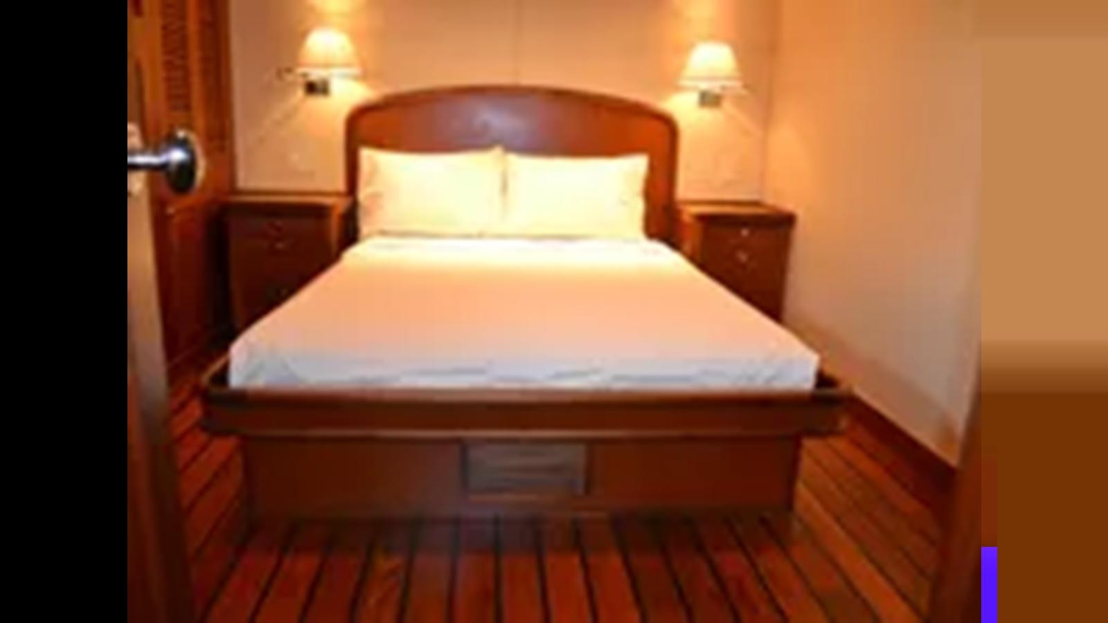 a bed with white sheets aboard 2018 ALLSEAS EXPEDITION Yacht for Sale