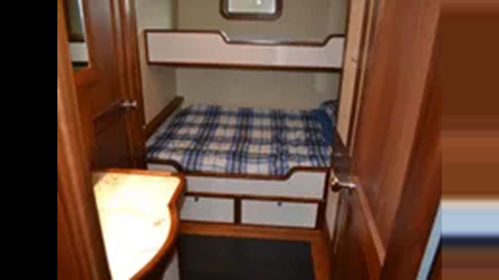 a bed with a striped comforter aboard 2018 ALLSEAS EXPEDITION Yacht for Sale