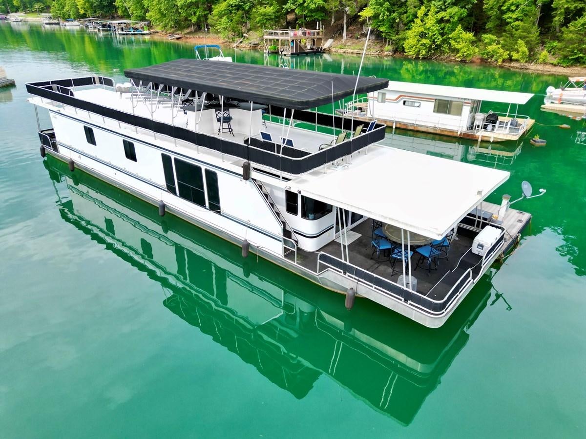 a boat docked at a pier aboard 2012 MAJESTIC 16 X 75WB HOUSEBOAT NLSD Yacht for Sale