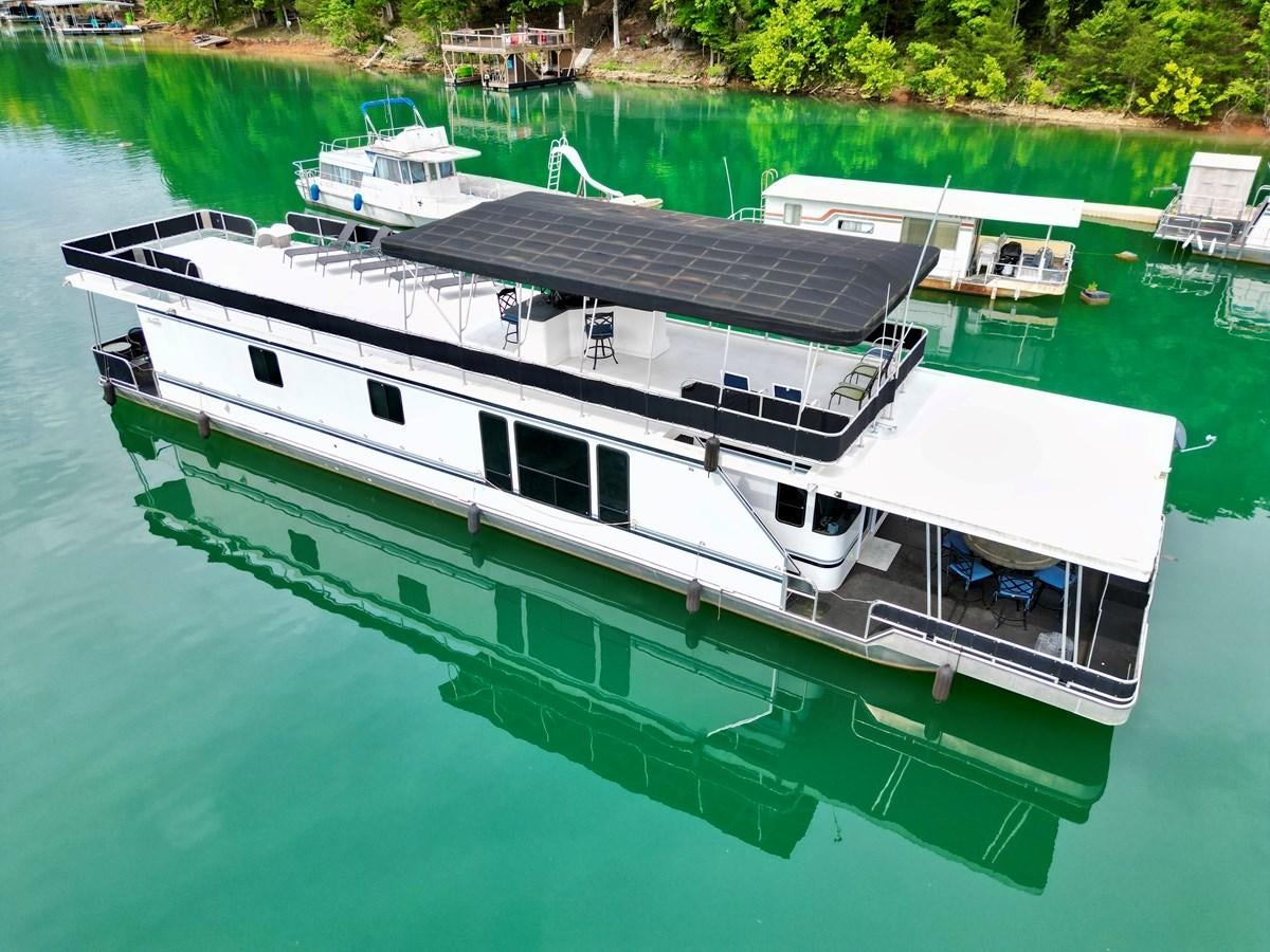 a boat on the water aboard 2012 MAJESTIC 16 X 75WB HOUSEBOAT NLSD Yacht for Sale