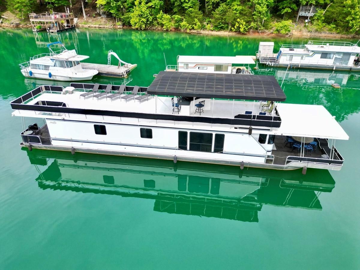 a boat docked at a pier aboard 2012 MAJESTIC 16 X 75WB HOUSEBOAT NLSD Yacht for Sale